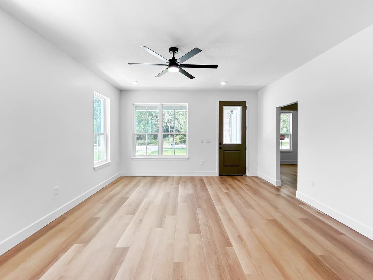 Open concept great room at 1010 Hickory Avenue Sanford - luxury vinyl floors, soaring ceilings, ceiling fan