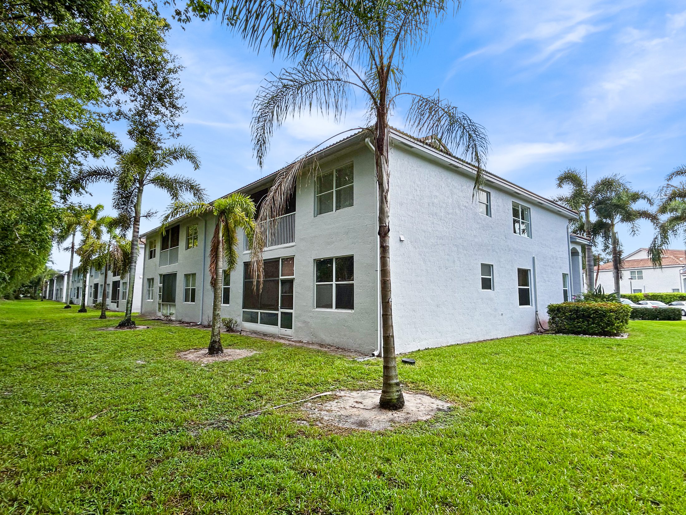 7880 Laina Lane #3 Boynton Beach — building exterior among mature palms