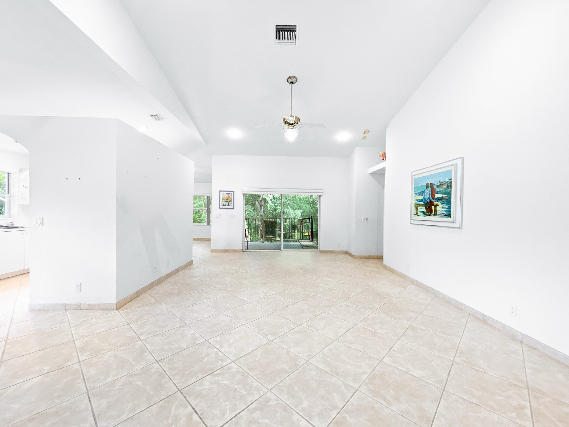 7880 Laina Lane #3 Boynton Beach — living area opening to screened balcony
